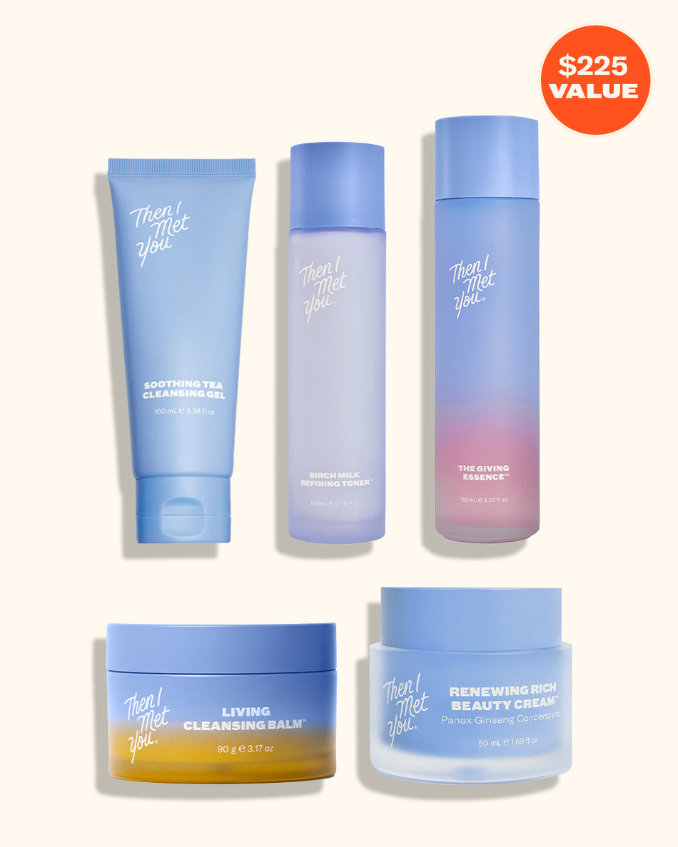 Set of four skincare products in blue and purple gradient packaging, including a tube, two bottles, and two jars with white.